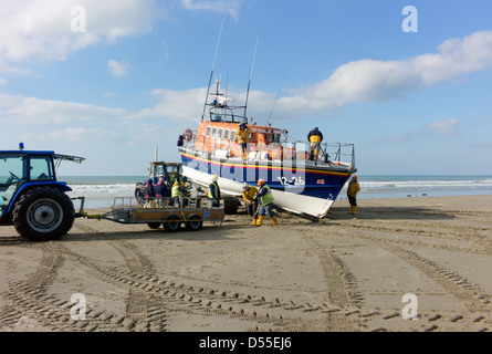 Barmouth lifeboat moira barrie is being recovered after practice in cardigan bay on a carriage for transport to the boathouse Stock Photo