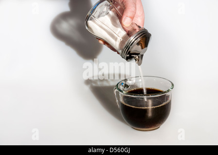 Morning sun lights a cup of coffee and sugar Stock Photo