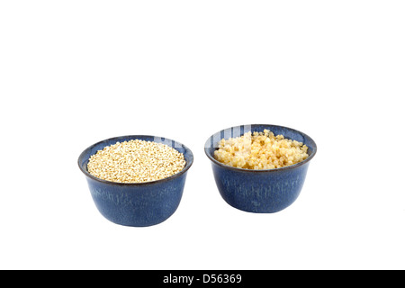 Organic uncooked and cooked bowls of Golden / White Quinoa (Chenopodium quinoa) Stock Photo