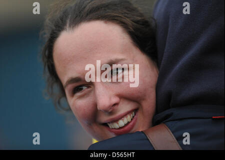 Eton Dorney, UK. 24th March 2013. Harriet Keane (seat 6) hugging a friend after the finish of The Newton Women's University Boat Race. Although Cambridge took an early lead, the Oxford team fought back to win by 1.75 lengths in 7m21s. Credit: Michael Preston / Alamy Live News Stock Photo