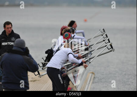 Eton Dorney, UK. 24th March 2013. The crew of the Oxford boat lifting it out of the water at the Dorney Lake jetty. Credit: Michael Preston / Alamy Live News Stock Photo