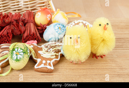 easter decoration, ginger bread, chicken and painted eggs wooden background Stock Photo