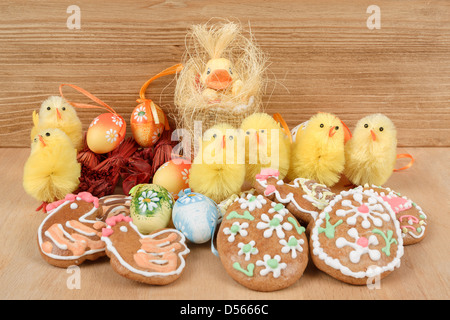 easter decoration, ginger bread, chicken and painted eggs wooden background Stock Photo