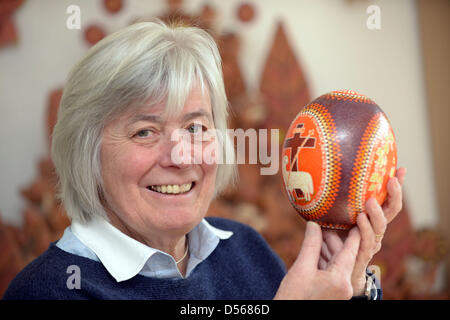 Collector Barbara Kruhoeffer presents a colorfully painted ostrich egg, which was designed with a special wax technique. Kruhoeffer's collection comprises about 5000 eggs from 70 regions of the world. Photo: Peter Steffen Stock Photo