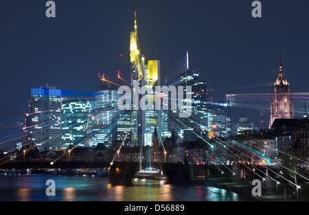Frankfurt, Germany. 25th March 2013. The skyline of the bank district of Frankfurt Main illuminate the city and create reflections in the water of the Main river. The skyline of the city changes with every new building. Photo: Boris Roessler/dpa/Alamy Live News Stock Photo