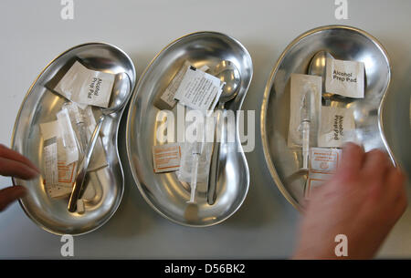 (dpa file) - A file picture dated 20 June 2008 shows syringes, spoons, and other drug injection devices being prepared for users at the addiction counsel centre 'Eastside' in Frankfurt am Main, Germany. Bavaria's state government has repeated its strong opposition to counseling, guiding, and consumption establishments for drug users. Photo: Boris Roessler Stock Photo