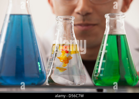 Hispanic student working in chemistry lab Stock Photo