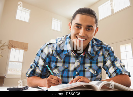 Smiling Hispanic man studying Stock Photo