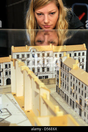 A young woman examines a true to scale model of the film set 'The Pianist' at the exhibition 'Roman Polanski- director and actor' at the Film Museum Potsdam in Potsdam, Germany, 17 November 2010. Until 14 August 2011 the museum presents the exhibition 'Roman Polanski- director and actor' with photos, screen-plays, costumes, film clips and posters on display, giving an insight into  Stock Photo