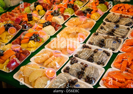Tropical fresh fruits cut and wrapped on the market in Krabi Town. Thailand Stock Photo