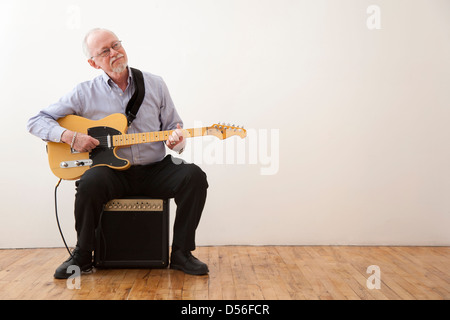 Caucasian man playing electric guitar Stock Photo