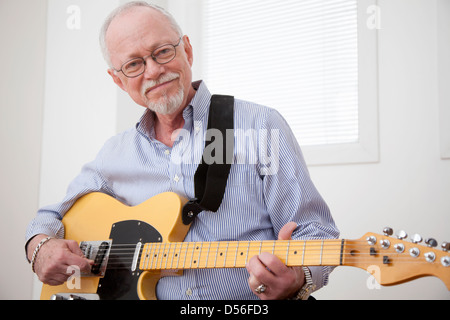 Caucasian man playing electric guitar Stock Photo