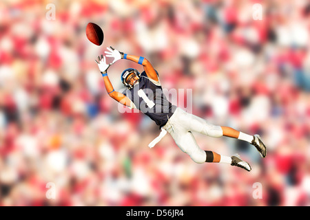 African American football player catching ball Stock Photo
