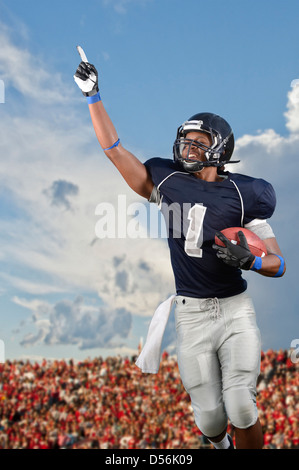 African American football player cheering in game Stock Photo
