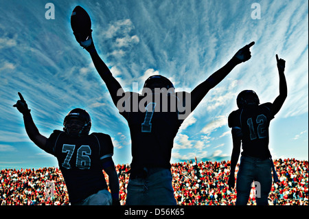 Football players cheering in game Stock Photo