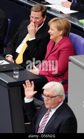 SPD parliamentary party leader Frank-Walter Steinmeier (front) speaks during the Bundestag budget debate in front of Chancellor Angela Merkel and Foreign Minister Guido Westerwelle (back) in Berlin, Germany, 17 March 2010. Steinmeier attacked the government harshly, accusing the CDU/FDP coalition of a complete lack of concept and inner disruption. Merkel prepared the citizens for a Stock Photo