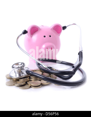 concept of listening to the money market, piggy bank with stethoscope on pile of coils Stock Photo