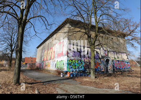 A decayed bunker sprayed with graffiti pictured in Kalrshorst district of Berlin, Germany, 22 March 2010. Until 2012, a total of 300 owner-occupied flats and 40 terraced houses will be constructed at a part of the premises. From 1936 on, German Wehrmacht errected a training centre for fortress engineer special troups, in 1945 Soviet army administration had their headquarters here.  Stock Photo