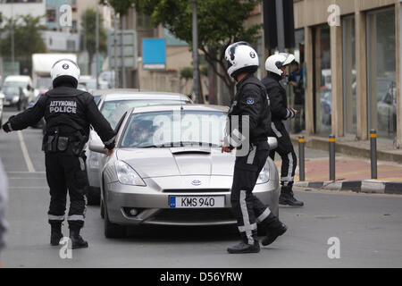 Nicosia, Cyprus. 26th March 2013.  Picture shows Police directing traffic to avoid students marching through the centre of Nicosia towards the Presidential Palace protesting against Laiki Bank headquarters in Nicosia, Cyprus. Credit: Jeff Gilbert / Alamy Live News Stock Photo