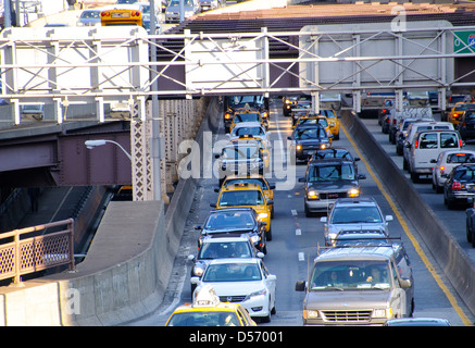 Traffic exiting the Queensboro 59th Street Bridge during evening rush hour, Midtown Manhattan, New York City, USA Stock Photo
