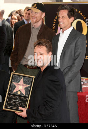 Australian actor Russell Crowe (front) poses with director Ron Howard (L) and producer Brian Grazer (R) while he receives the 2,404th star on the Hollywood Walk of Fame in Hollywood, California, USA, 12 April 2010. Crowe, a three-time consecutive Academy Award Best Actor nominee, took home the Oscar for his performance in ''Gladiator''. Photo: Hubert Boesl Stock Photo
