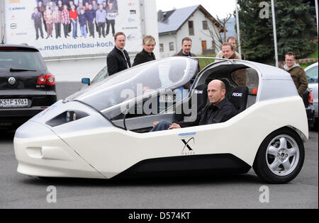 Wolfgang Moescheid drives the electronic vehicle 'TW4XP' to a presentation in Baunatal, Germany, 16 April 2010. The car was developed in Rosenthal, Germany, and is the only one to participate in the international competition 'Progressive Insurance Automotive X Prize' in the USA. The prize is endowed with all in all ten million US dollars and is awarded to economical vehicles of all Stock Photo