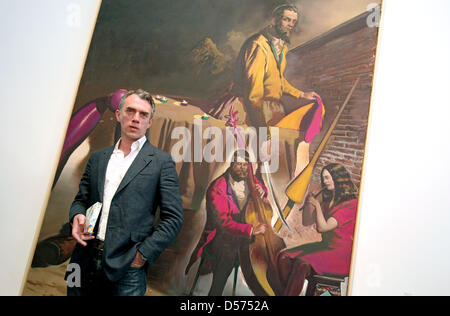 Leipzig-based painter Neo Rauch stands in front of his painting 'Der Reiter' ('The Horseman') at the Museum of Fine Arts ('Museum der Bildenden Kuenste') in Leipzig, Germany, 16 April 2010. The museum hosts a retrospective of Rauch's works titled 'Neo Rauch. Begleiter' ('Neo Rauch.Companion') honouring the painter's 50th birthday. The second part of the exhibition will open the fol Stock Photo