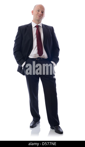 Full length portrait of a young businessman standing with his hands in the pockets. Stock Photo