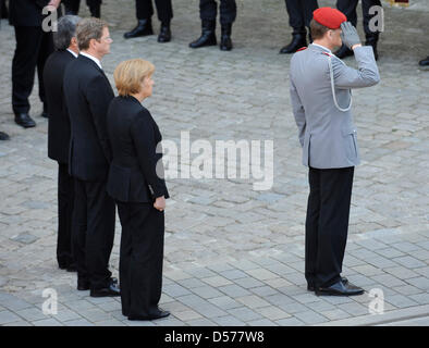 German Chancellor Angela Merkel (C), German Foreign Minister Guido Westerwelle (2-L) and Afghan Minister of Foreign Affairs Zalmai Rassoul (L) attend the funeral service for the four killed German soldiers at the Cathedral ('Liebfrauenmuenster') in Ingolstadt, Germany, 24 April 2010. Members of the German Bundeswehr, politicians, family relatives and friends attended the funeral se Stock Photo