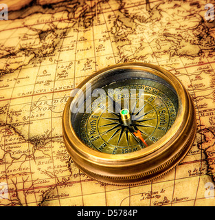 Compass lies on an ancient world map Stock Photo - Alamy
