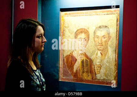 London, UK. 26th March, 2013. A woman looks at the wall painting of the baker Terentius Neo and his wife, AD 50-79 at the press preview of Life and Death - Pompeii and Herculaneum exhibition that opens at British Museum on the 28th of March, bringing together over 450 fascinating objects, both recent discoveries and celebrated finds from earlier excavations. Credit: Piero Cruciatti/Alamy Live News Stock Photo