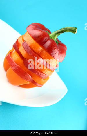 slices of colorful sweet bell pepper on blue background Stock Photo