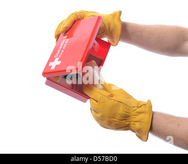 construction worker with glove taking a bandage from a first aid box Stock Photo