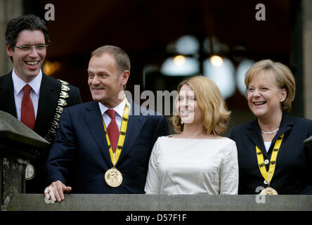 (L-R) Aachen Mayor Marcel Philipp, Polish Prime Minister Donald Tusk, his wife Malgorzata Tusk and German Chancellor Angela Merkel smile after the awarding ceremony of Charlemagne Prize in Aachen, Germany, 13 May 2010. Mr Tusk was given the award for being a 'convincing and convinced European.' During the award ceremony, Mr Tusk was lauded as an outstanding proponent of freedom, de Stock Photo