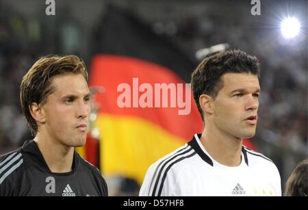 (dpa fil) A file picture dated 09 October 2009 of Germany skipper Michael Ballack (R) and goalie Rene Adler singing the national anthem ahead of a match in Hamburg, Germany. Germany skipper Michael Ballack will miss the 2010 FIFA World Cup in South Africa because of injury, the German Football Association (DFB) confirmed 17 May 2010. The midfielder of English Premier League side Ch Stock Photo