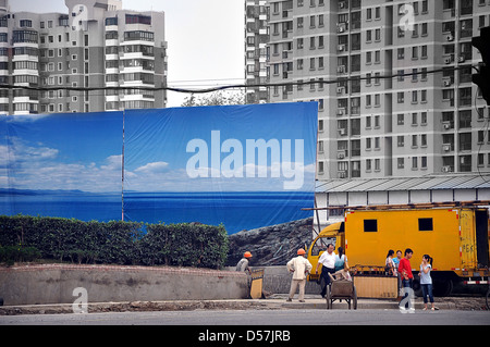 Giant posters hiding a construction site in Shanghai - China Stock Photo