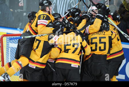 Germany's players cheer after winning the IIHF Ice Hockey World Championships quarter-finals match Germany vs Switzerland in Mannheim, Germany, 20 May 2010. Photo: ARNE DEDERT (EDITORIAL USE ONLY) Stock Photo