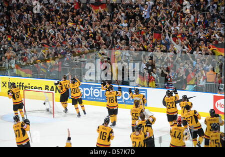 Germany's players cheer after winning the IIHF Ice Hockey World Championships quarter-finals match Germany vs Switzerland in Mannheim, Germany, 20 May 2010. Photo: ARNE DEDERT (EDITORIAL USE ONLY) Stock Photo