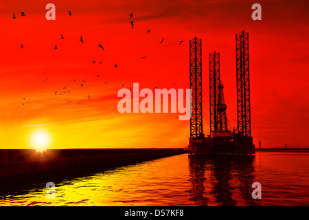 Oil drilling rig in sunset time. Stock Photo