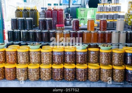 canned at home fruit vegetables and berries on the shelves of rural market Stock Photo