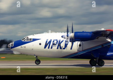 Gromov Air (Irkut-Avia) Antonov An-12 touching down on runway at Farnborough International Airshow 2012 Stock Photo