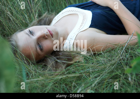 beautiful teen girl lying in green grass Stock Photo - Alamy