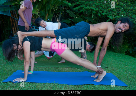 Bali, Indonesia-march 20, 2013: Rows of male and female adults, lying on colourful mats in a yoga class at Bali Spirit Festival. Stock Photo