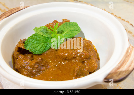 Nonya Peranakan Curry Beef Rendang with Mint Leaves Garnish Closeup Stock Photo