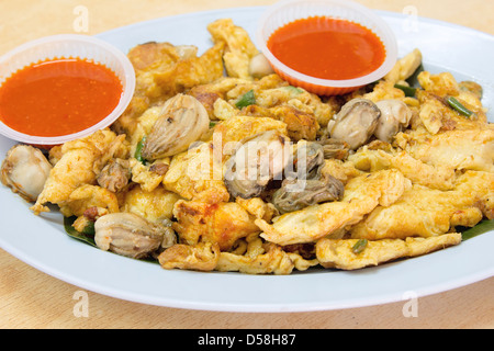 Southeasat Asian Fried Baby Oyster Omelette Oh Chien with Chili Sauce Closeup Stock Photo