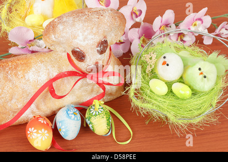 Easter lamb with painted eggs, nest and easter decorations Stock Photo