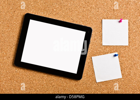 touch tablet with note papers on cork board Stock Photo