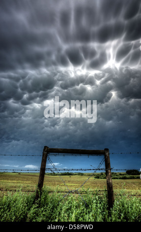 mammatus Bubble Storm Clouds Saskatchewan with fence Stock Photo