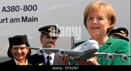 Smiling, German chancellor Angela Merkel holds a model of the Airbus A380 in her hands, which was previously presented to her by Lufthansa head Wolfgang Mayrhuber during the International Aerospace Exhibition (ILA) at airport Berlin-Schoenefeld, Germany, 08 June 2010. The ILA is open in Germany's capitol until 13 June 2010. Photo: WOLFGANG KUMM Stock Photo