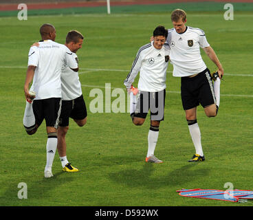 German internationals Jerome Boateng (L-R), Lukas Podolski, Mesut Oezil and Per Mertesacker pictured during a training session in Super Stadium in Atteridgeville near Pretoria, South Africa, 08 June 2010. The team prepares for the upcoming FIFA World Cup 2010 that will start on 11 June 2010. Photo: BERND WEISSBROD Stock Photo